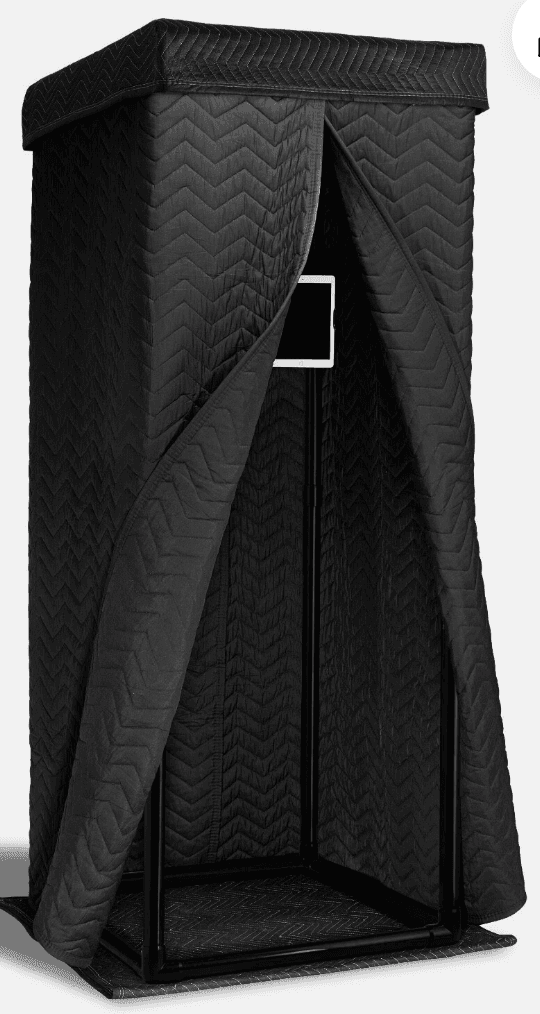 Black soundproof recording booth with a quilted fabric exterior and open front entrance.