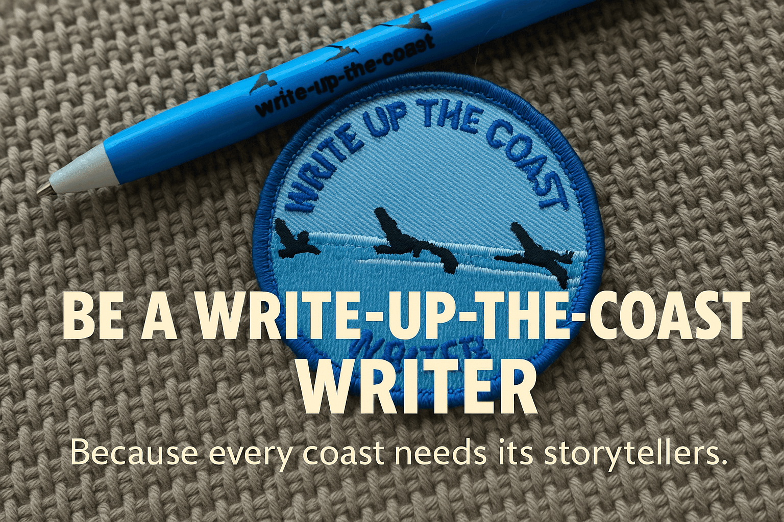 Blue pen and embroidered patch with 'Write Up The Coast' logo, on knitted fabric background.